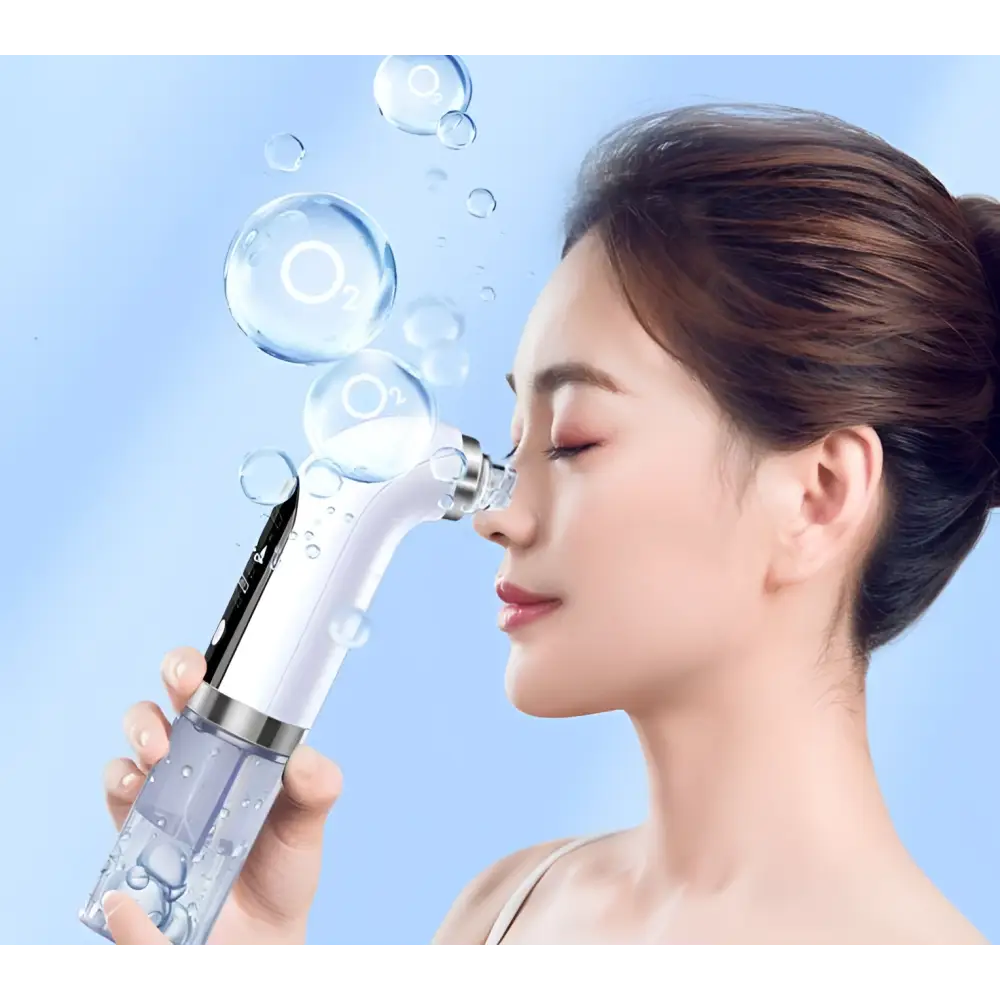 A sleek white and silver facial cleansing oxygen bubble blackhead remover pore vacuum with transparent water tank