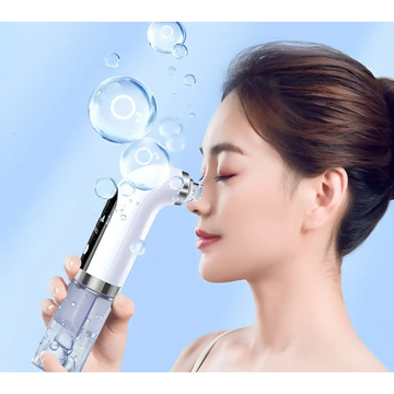 A sleek white and silver facial cleansing oxygen bubble blackhead remover pore vacuum with transparent water tank
