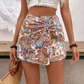 White mini skirt featuring knot shorts high waist fake two-piece design with vibrant multi-colored paisley pattern