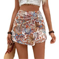 A high-waisted skirt featuring knot shorts high design with vibrant orange blue paisley on cream waist fake two-piece fabric