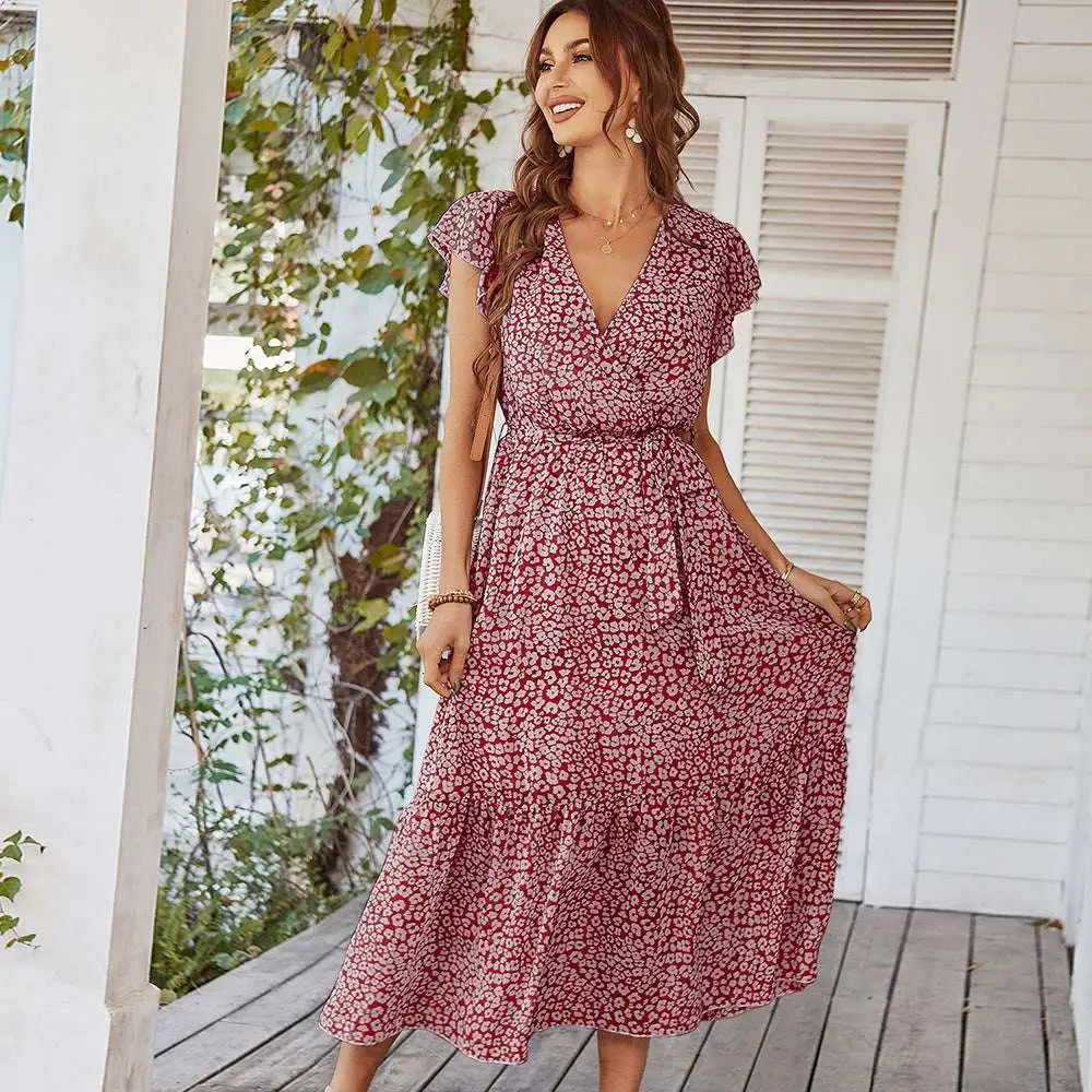A flowing red and white floral summer dress with ruffle cap sleeves and short ruffled sleeves perfect for summer wear