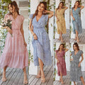 A flowing pastel floral summer dress with v-neckline, ruffle cap sleeves, and tiered hem perfect for warm weather