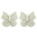 Pair of pale green leather butterfly bag clip children’s barrettes made from textured leather with cream fabric ties