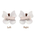 A pair of delicate white leather butterfly bag clip children’s barrettes with soft fabric wings and light pink ribbon band