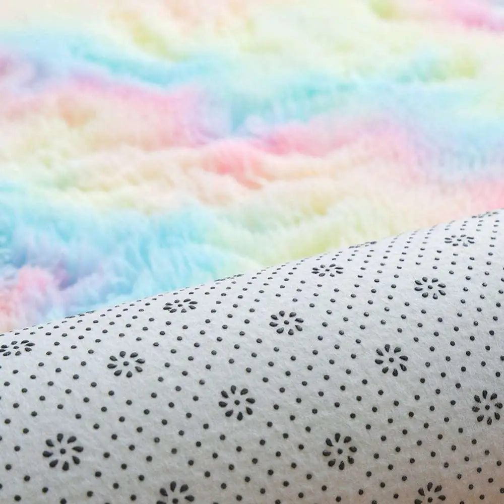 A soft white fabric living room carpet with a subtle black floral pattern in pastel rainbow nordic diameter round shape