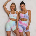 Pastel tie dye crop bra and shorts workout set featuring high waisted shorts in soft pink blue and lavender hues