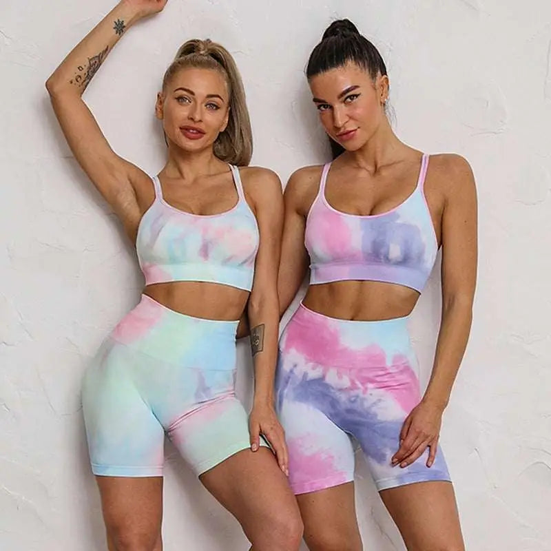 Pastel tie dye crop bra and shorts workout set featuring high waisted shorts in soft pink blue and lavender hues