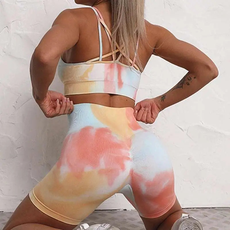 Pastel tie dye athletic two-piece set with crisscross straps seamless fabric and high waisted shorts workout set
