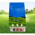 Blue and green pasture electronic host with digital display showing three buttons and red black terminals for livestock fencing