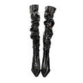 Black patent thigh high boots with ruched glossy texture and pointed toe featuring an autumn stiletto heel design