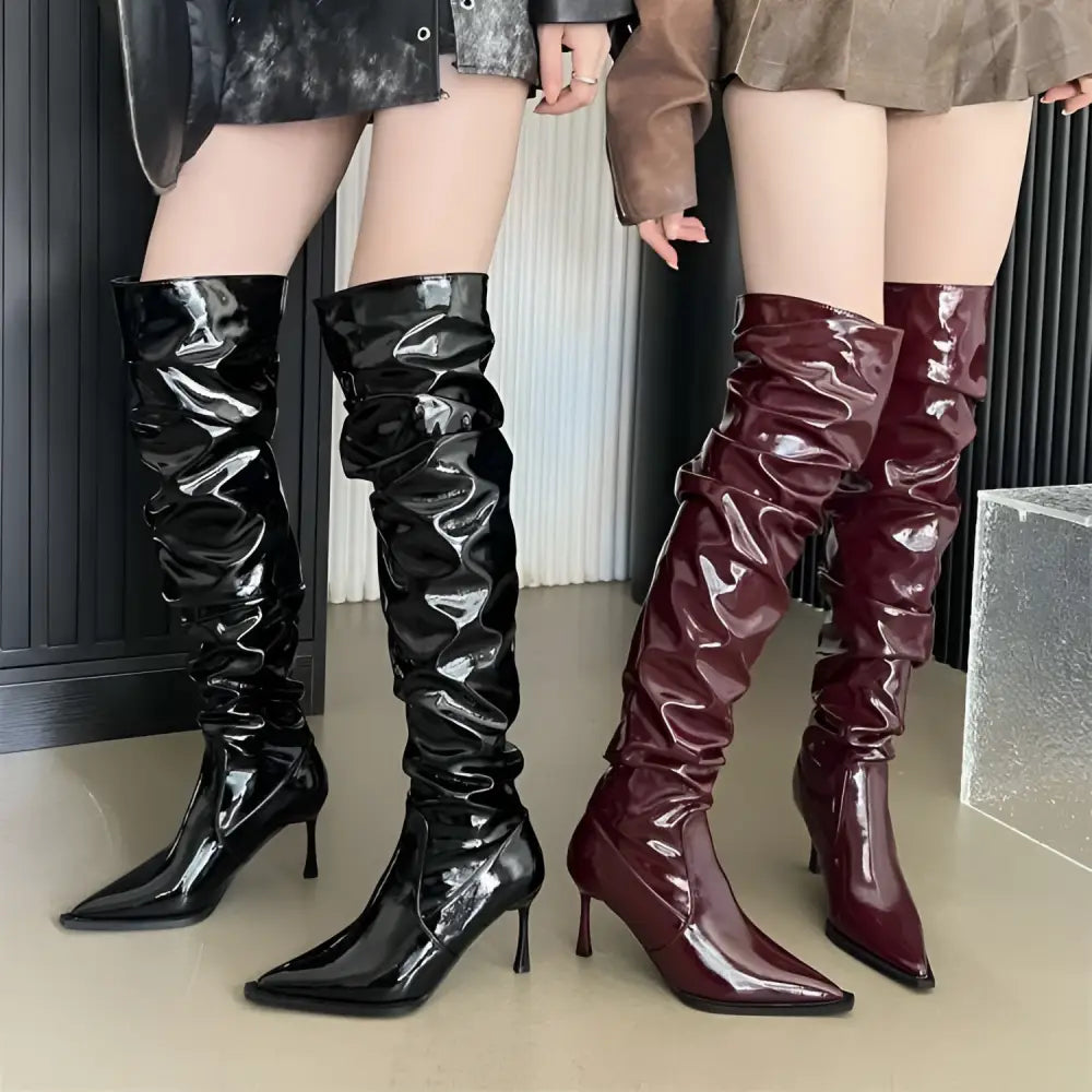 Black and burgundy patent leather thigh high boots with ruched detailing and sharp pointed toes autumn stiletto heel