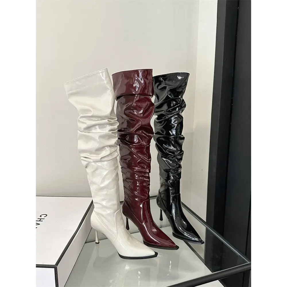 Three glossy thigh high boots in white burgundy and black patent with crinkled faux leather and autumn stiletto heel designs