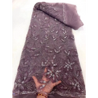 A delicate mauve peach ribbon flower beaded tulle lace fabric with intricate floral patterns and rhinestone embellishments