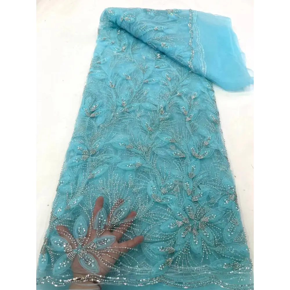 Delicate turquoise peach ribbon flower beaded tulle lace fabric with intricate floral patterns and silver rhinestones