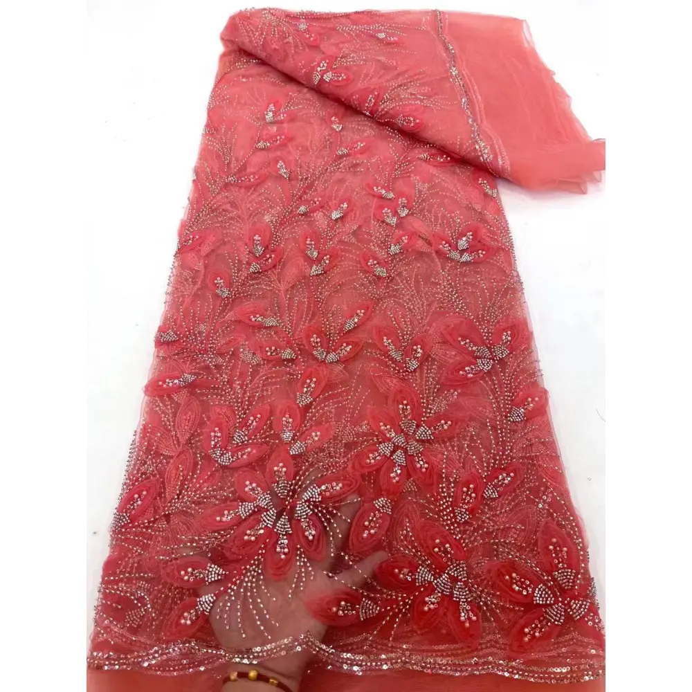 A vibrant coral-red peach ribbon flower beaded tulle lace fabric with intricate floral appliqués and silver beading