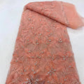 A delicate peach ribbon flower beaded tulle lace fabric with intricate floral embroidery and sparkling beading
