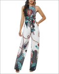 A vibrant tropical peacock feather print jumpsuit with halter neckline wide-leg design and tied waistband in teal black red and white