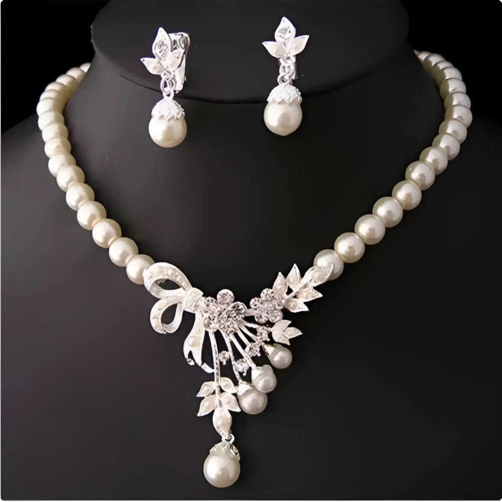 Elegant pearl and crystal bridal ornaments necklace set featuring a central floral bow pendant for wedding gowns
