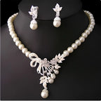 Elegant pearl and crystal bridal ornaments necklace set featuring a central floral bow pendant for wedding gowns