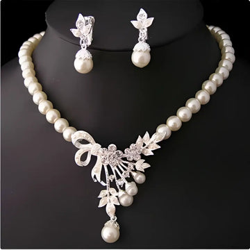 Elegant pearl and crystal bridal ornaments necklace set featuring a central floral bow pendant for wedding gowns