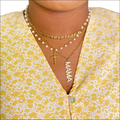 Gold-toned layered necklaces with pearls and cross pendant featuring a mama charm for luxury women’s fashion