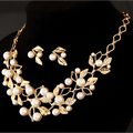 Gold-toned pearl clover necklace jewelry and earrings featuring intricate leaf design with rhinestones and pearls