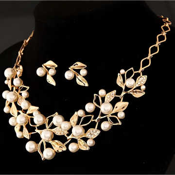 Gold-toned pearl clover necklace jewelry and earrings featuring intricate leaf design with rhinestones and pearls