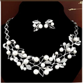 Silver leaf and pearl clover necklace jewelry set with intricate detailing and matching earrings featuring elegant design