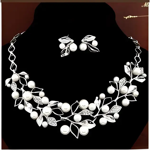 Silver leaf and pearl clover necklace jewelry set with intricate detailing and matching earrings featuring elegant design