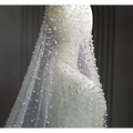 Pearl long luxury wedding veil with delicate white pearl beaded accents on sheer fabric for elegant bridal wear