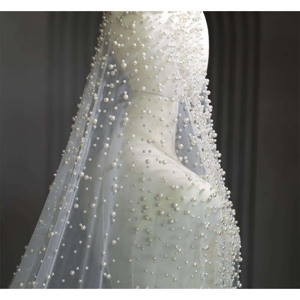 Pearl long luxury wedding veil with delicate white pearl beaded accents on sheer fabric for elegant bridal wear