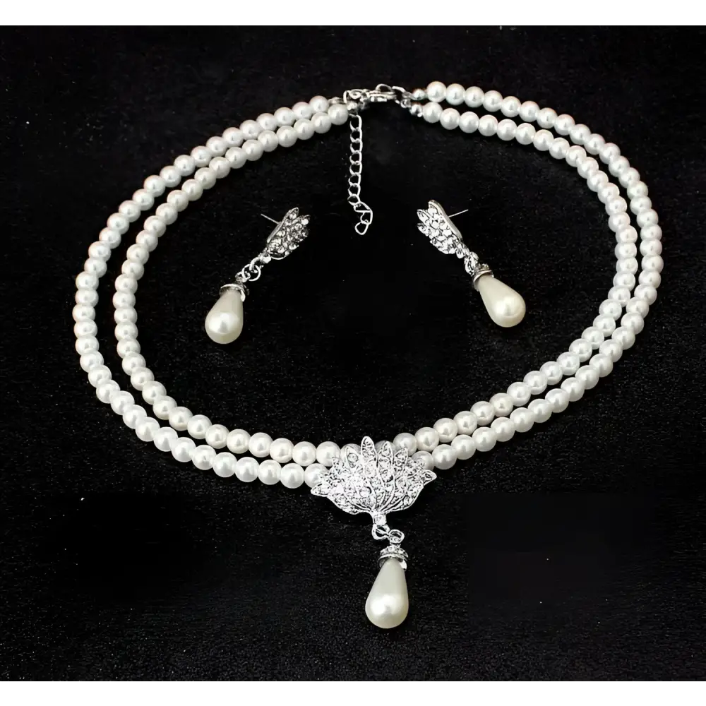 Elegant two-strand pearl lotus pendant alloy necklace set with silver-toned pendant and matching earrings for bride wedding