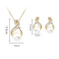 Gold-toned pearl necklace and earrings set featuring swirling design with clear crystals and central white pearls for dinner bridal use