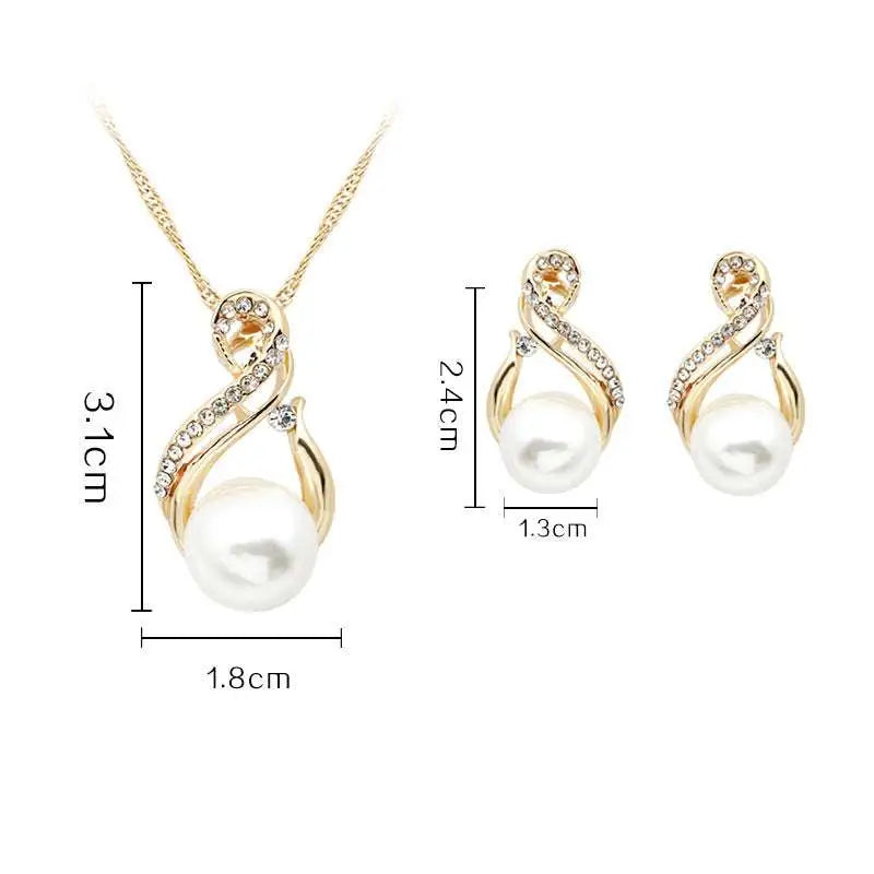 Gold-toned pearl necklace and earrings set featuring swirling design with clear crystals and central white pearls for dinner bridal use