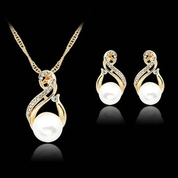 Gold-toned pearl necklace and earrings set featuring swirling designs with clear crystals and prominent white pearls for dinner bridal use