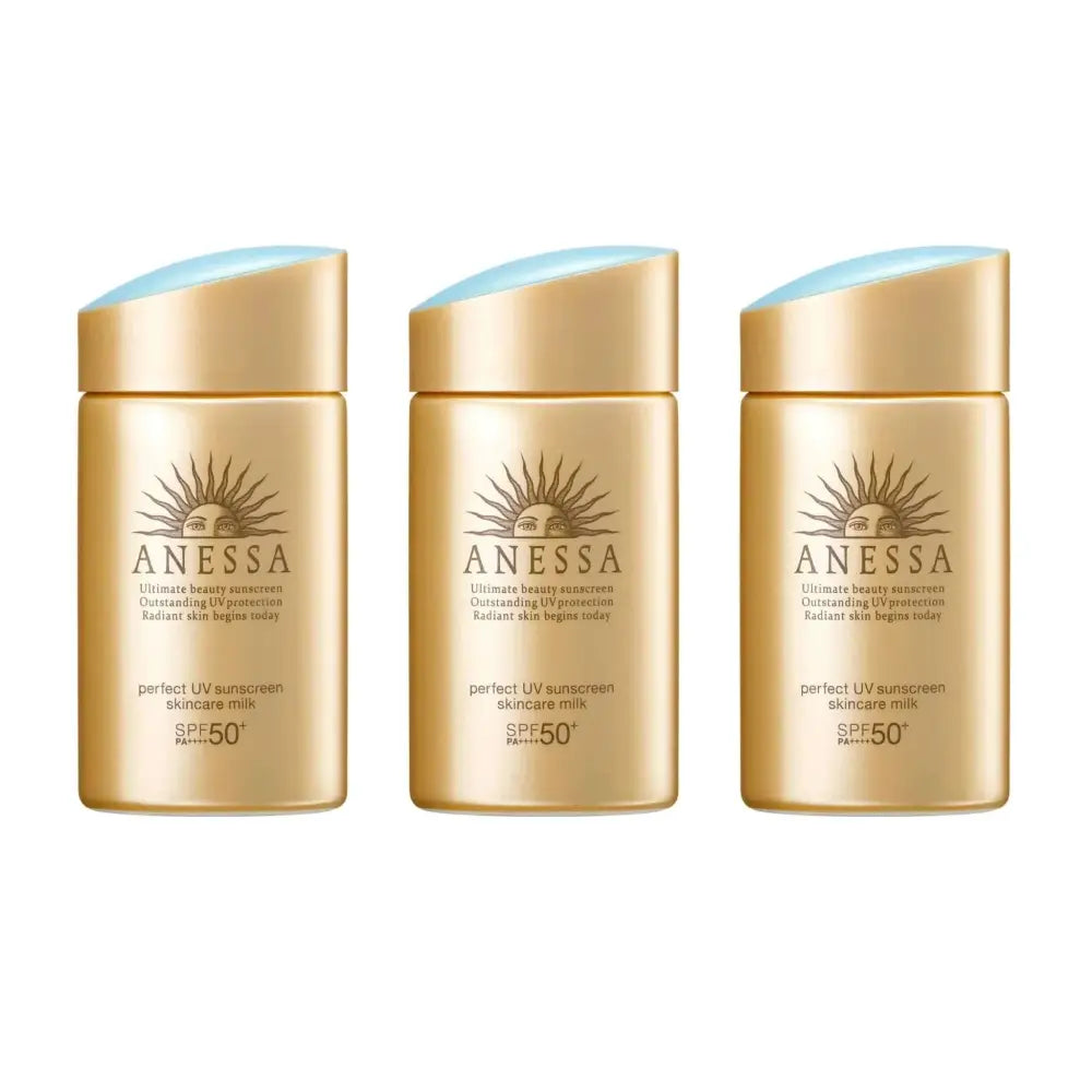 Three golden anessa perfect uv sunscreen skincare milk bottles with light blue caps in a 3pc set for sun protection