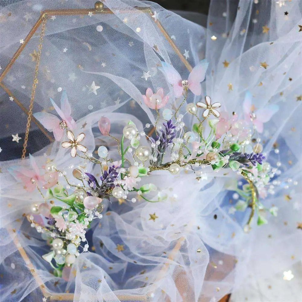 A delicate performance butterfly garland headdress featuring pink white and purple flowers pearl beads on gold wire