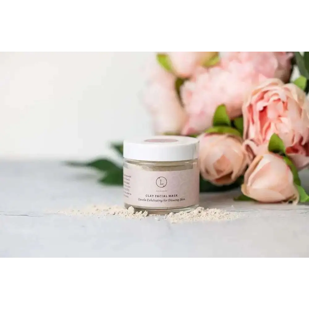 A clear jar with white lid contains light beige clay facial mask for gentle exfoliation in personalized Ashley pampering natural skincare mom gift