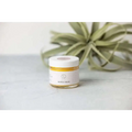 A small glass jar with white lid containing golden-yellow nipple balm for personalized Ashley pampering natural skincare mom gift