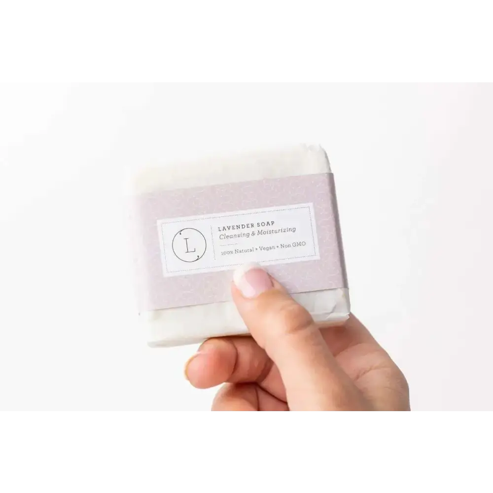 A pale lavender rectangular soap wrapped in purple paper labeled lavender soap for personalized ashley pampering natural skincare mom gift