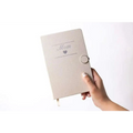 A soft beige textured notebook embossed with mom and a silver heart for the personalized ashley pampering skincare mom gift