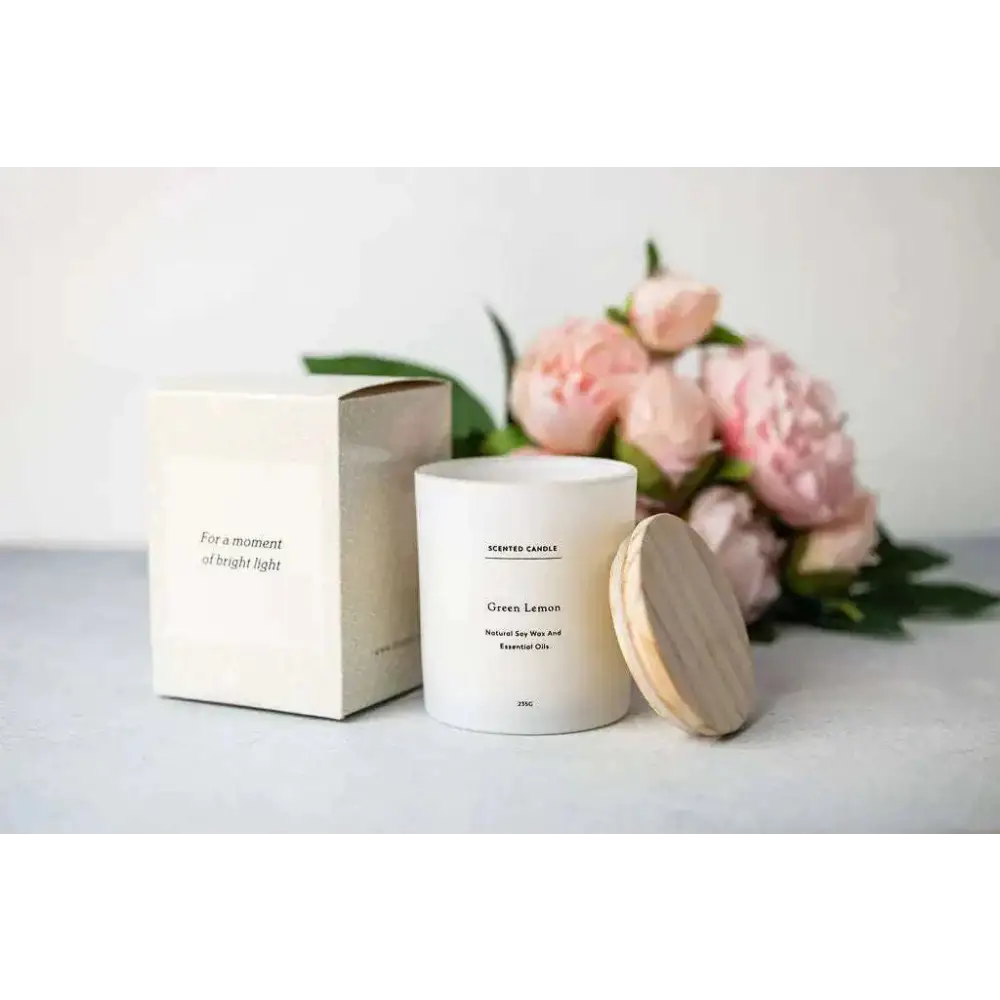 White cylindrical scented candle labeled green lemon with wooden lid made of natural soy wax for personalized ashley pampering natural skincare mom gift