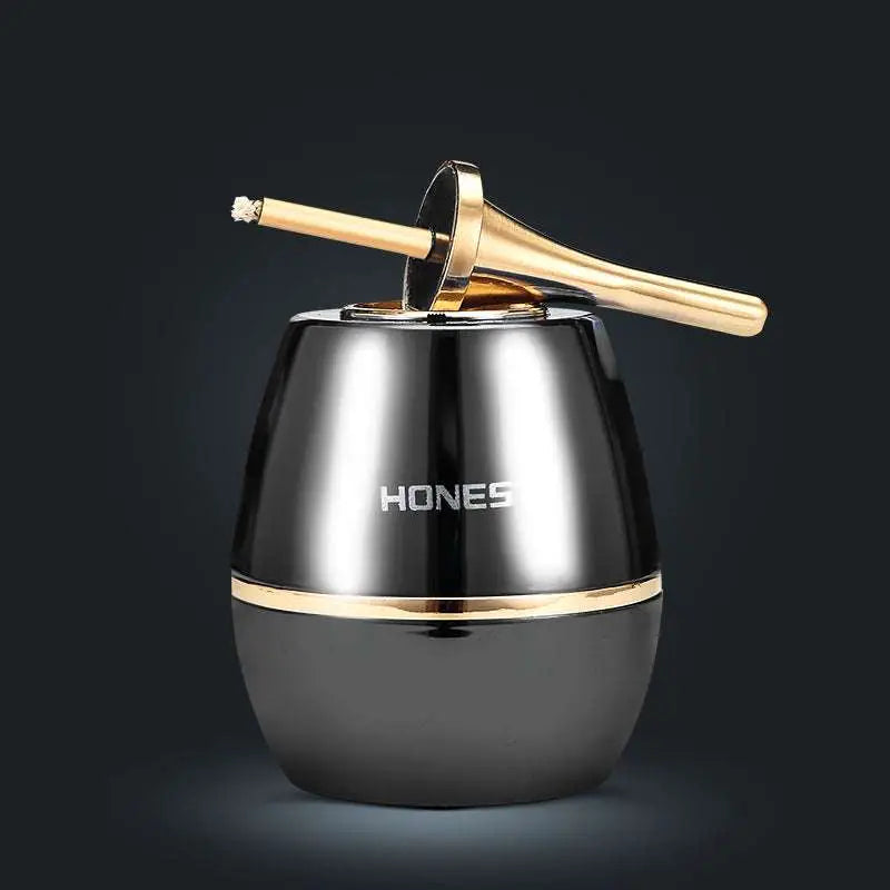 Black and gold hones branded ashtray with a sleek, reflective metallic finish.