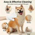 White pet cleaning gloves gently wiping a shiba inu’s face for effective pet cleaning and grooming