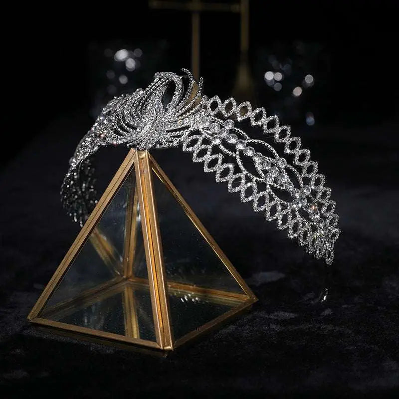 A sparkling silver rhinestone crown luxury bridal headdress with an intricate phoenix motif and delicate design
