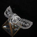 A sparkling silver rhinestone crown luxury bridal headdress with intricate crystal phoenix motif and ornate swirling design