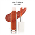 A sleek glass tube of phhera sun shine brick red lip gloss with white applicator wand for luxury women’s fashion looks