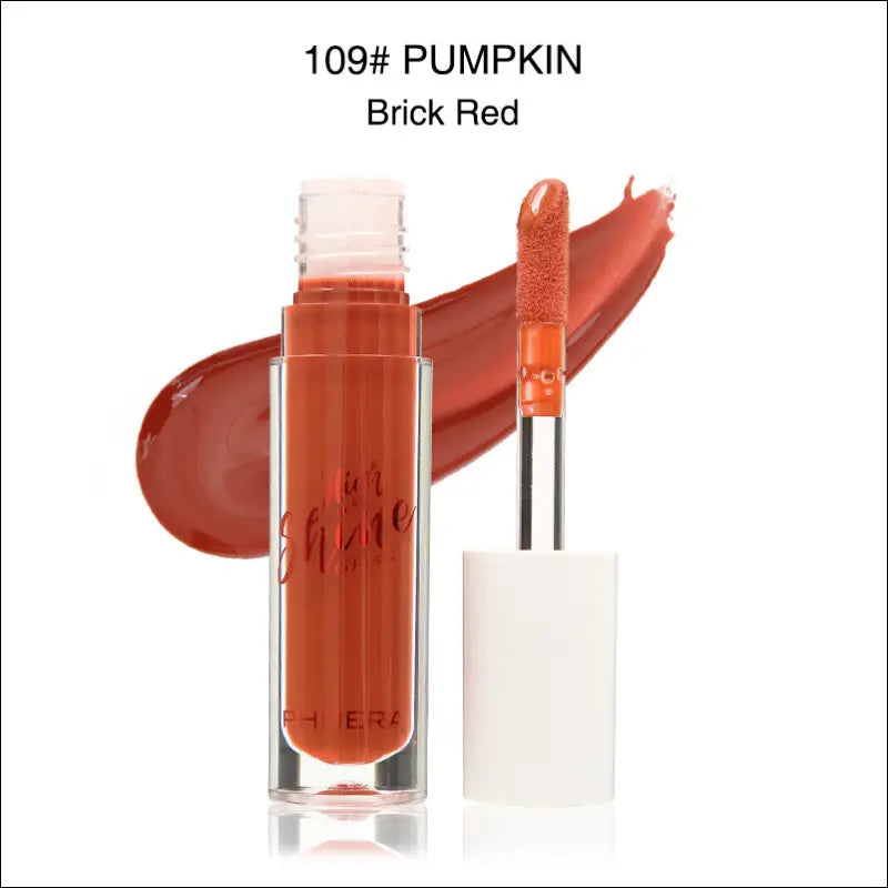 A sleek glass tube of phhera sun shine brick red lip gloss with white applicator wand for luxury women’s fashion looks