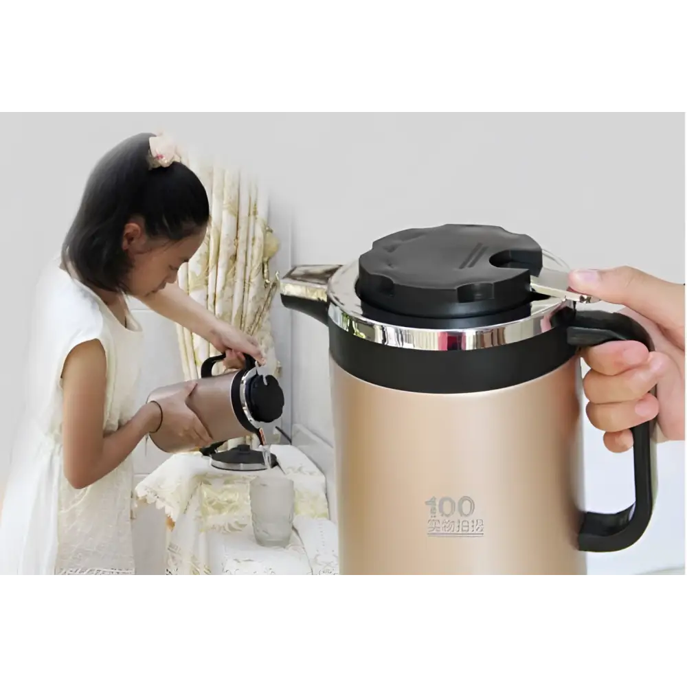 Gold-colored stainless steel electric kettle double insulated with black lid handle and silver metallic rim around top