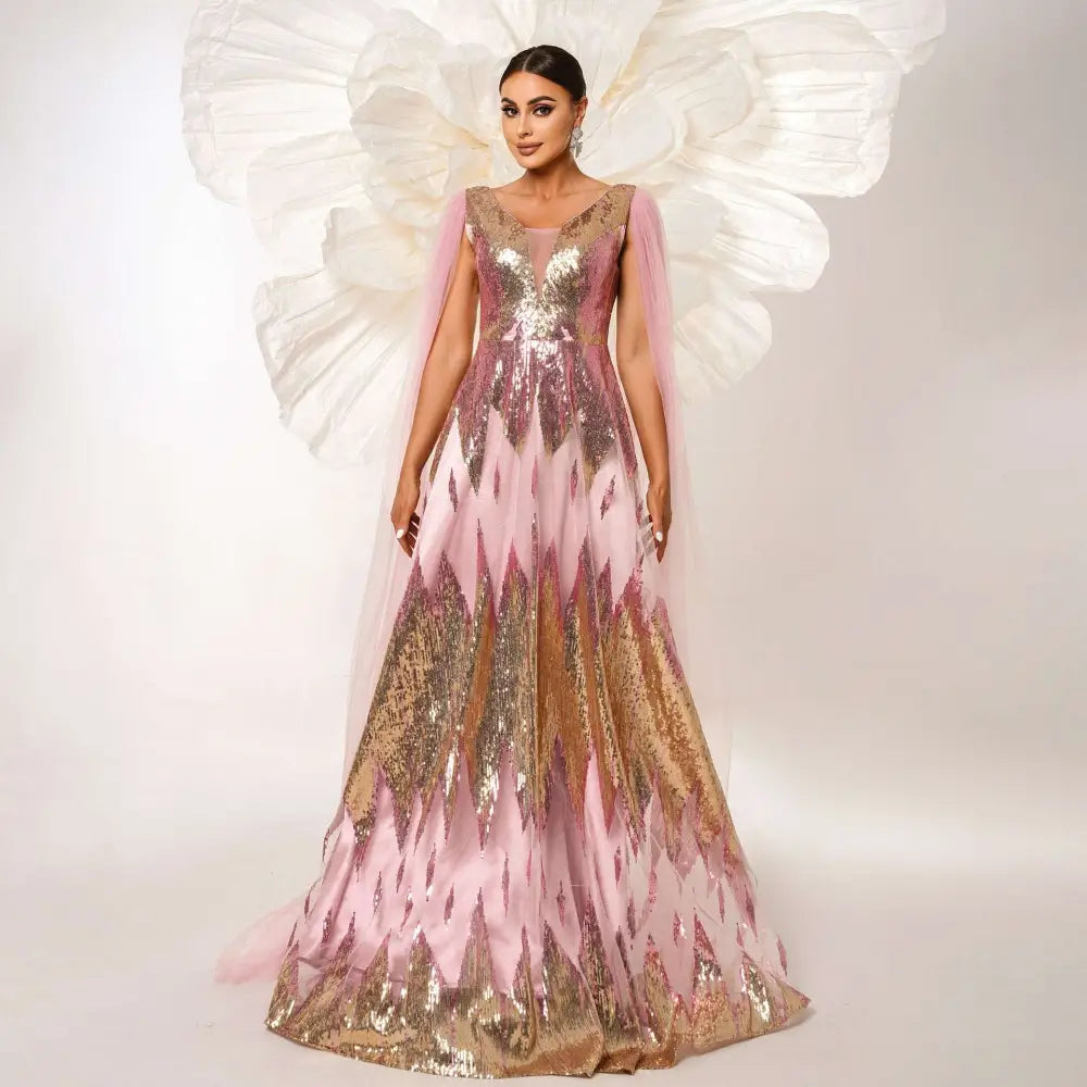 A pink and gold mesh long sleeve sequins large swing dress with a flowing gown and sheer capelet